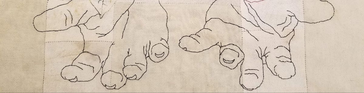 Detail of an embroidered piece: several small hands or paws outlined in stitching on cloth.